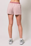 Person wearing red and white striped shorts on a plain background