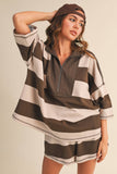 Woman wearing a brown and white striped outfit with a cap on a beige background
