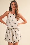 Woman wearing a polka dot dress on a beige background