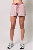 Person wearing pink and white striped shorts on a plain background