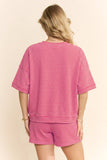 Person wearing a pink striped outfit on a beige background