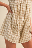 Plaid dress with a drawstring waist on a beige background