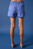 Blue shorts with floral embroidery on a blue background
